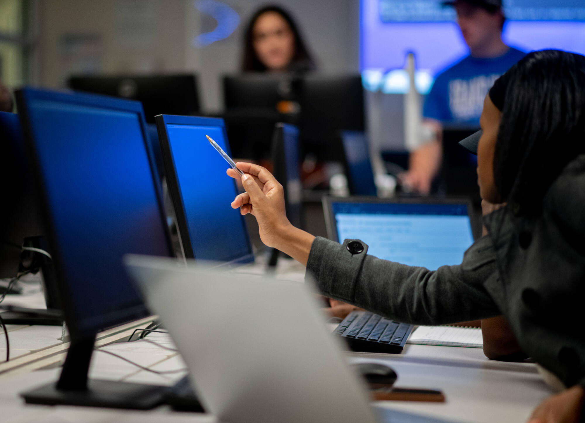 Student pointing to computer monitor